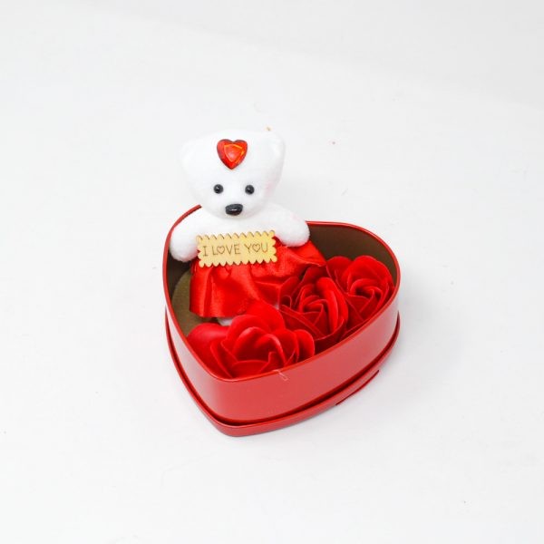 Red heart-shaped box with a teddy bear and roses